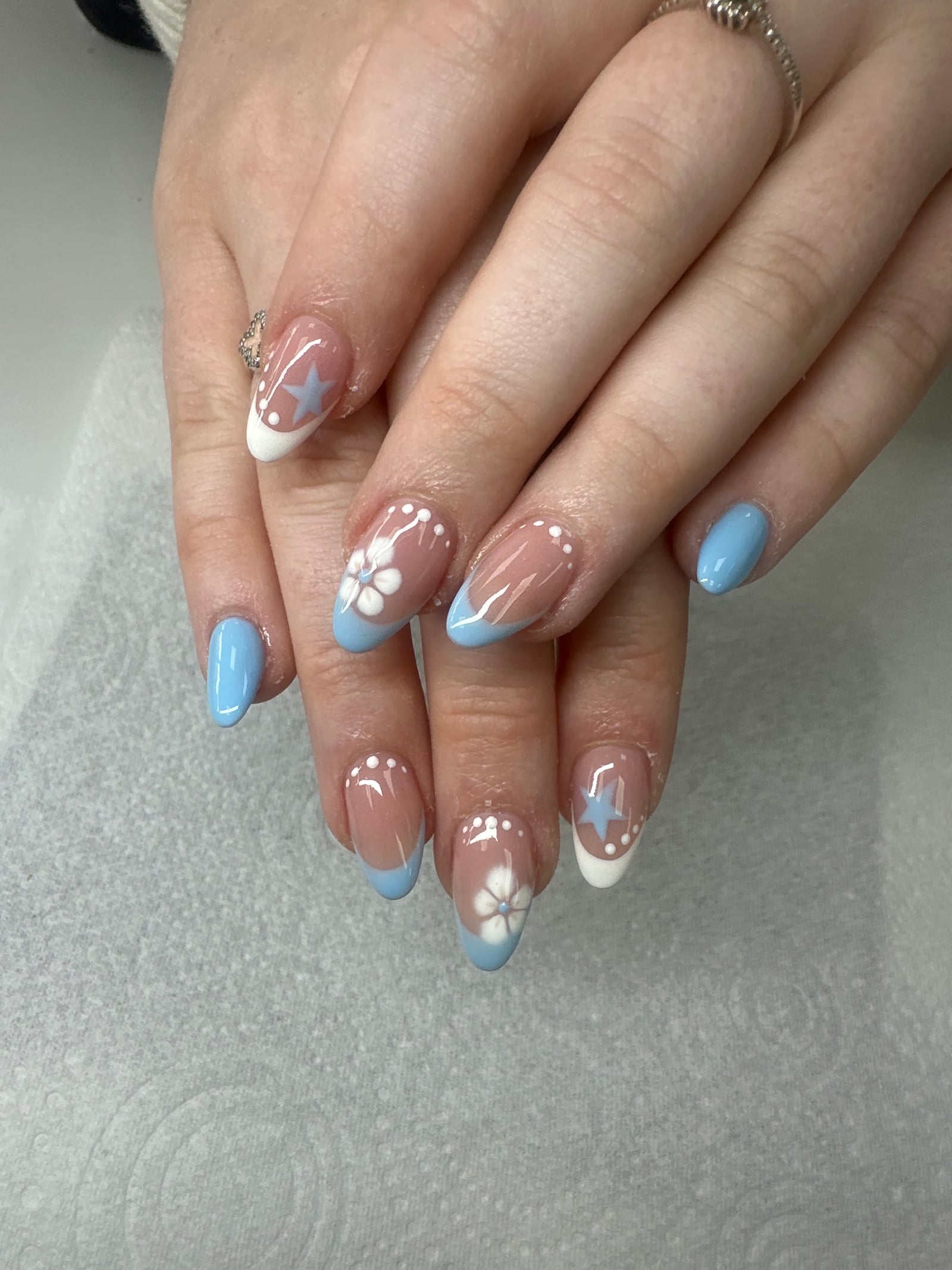 Blue and white flower and star nail design photographed by Heidi Parker