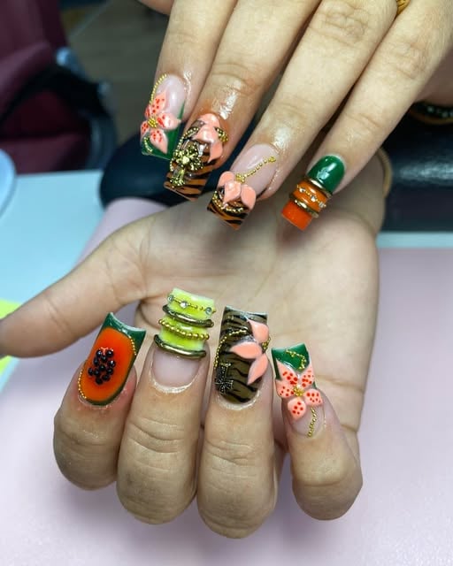 Colourful decorated nail design with green and orange details